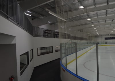 View from  of the ice rink dasher boards and lobby viewing area windows